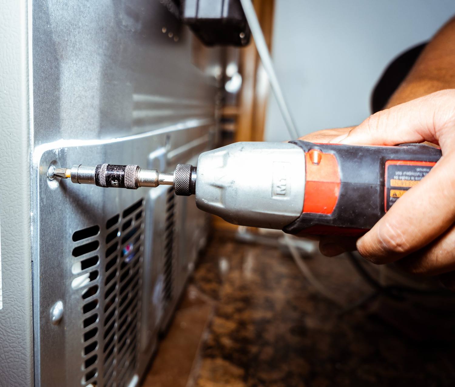 Doctor Maintenance factory-certified technician repairing an appliance in Baltimore, MD